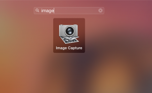 Just open the Launchpad, and find Image Capture. (Start typing in Image Capture. It will be the only thing that comes up.) You could use iPhoto, but trust me, you don't want to.